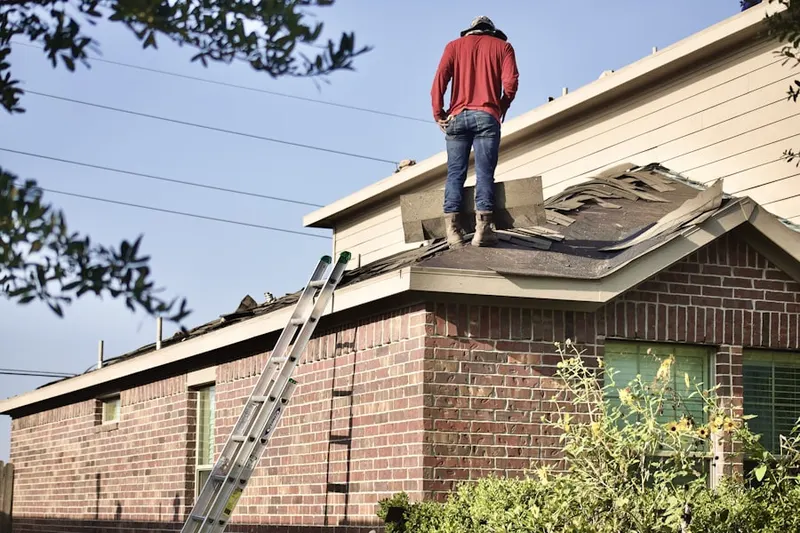 Professional roofer working on a residential roof in Justin